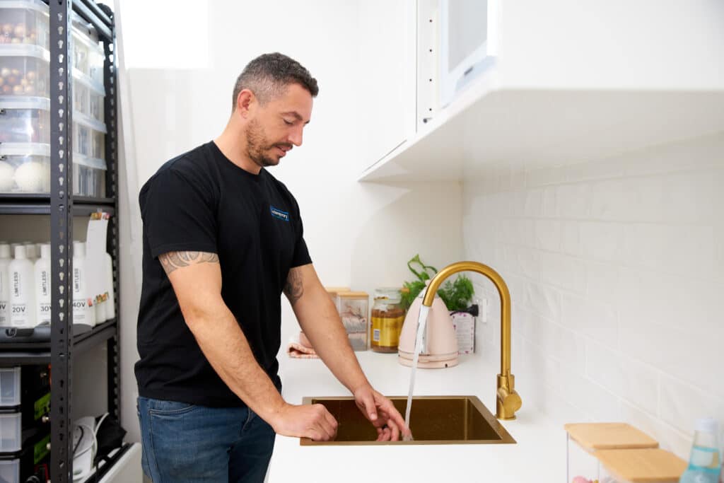 Contemporary Plumbing plumber fixing sink tap in Canberra