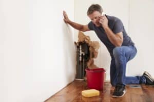 A homeowner with a burst pipe calls for help.