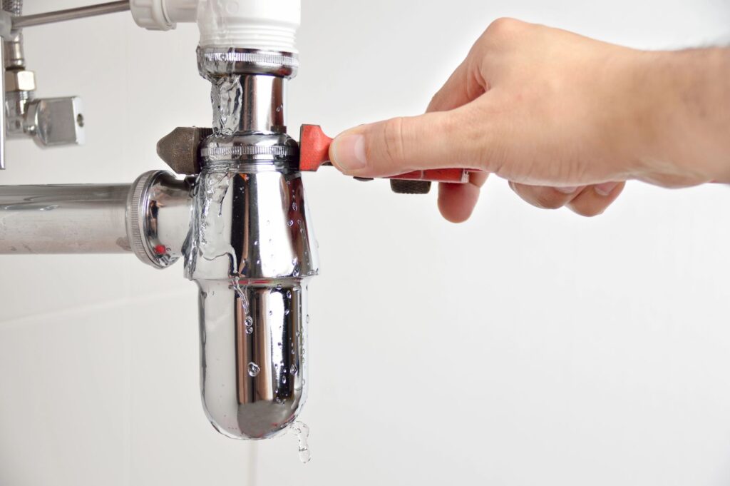 plumber fixing a leaking tap
